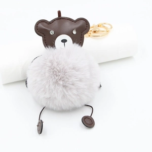 Cute brown faux fur bear keychain with golden metal clasp and leather accents