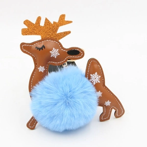 Close-up of reindeer faux fur pompom keychain with white stitching and gold glitter antlers