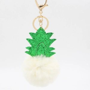 Detail of pineapple plush keychain with green glitter leaves and white pom-pom