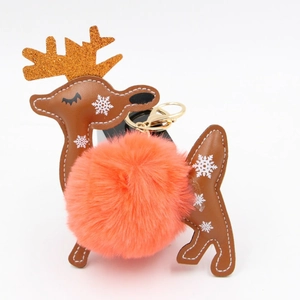 Detail of Christmas reindeer keychain with orange faux fur ball and gold metal clasp