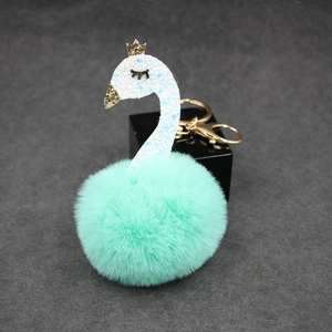 Elegant mint green swan pom pom keychain with gold crown and sparkling sequins