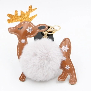 Detail of Christmas reindeer keychain with white faux fur pompom and golden glitter antlers
