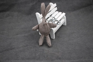 Gros plan du porte-clés lapin en peluche à carreaux marron avec fermoir mousqueton