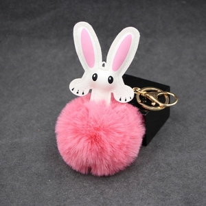 Pink fluffy rabbit fur pompom keychain with white leather ears and gold metal clasp