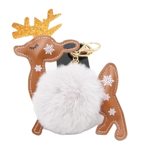 Christmas reindeer keychain with white faux fur pompom and golden glittery antlers