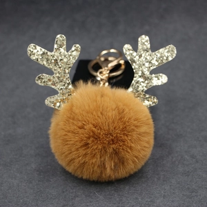 Close-up of plush reindeer antler keychain with gold sequins and metal lobster clasp