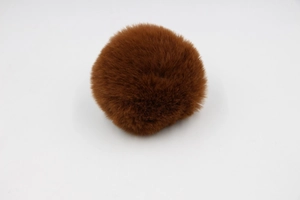 Detailed close-up showing the dense texture and soft fibers of an 8cm brown faux fur pom pom