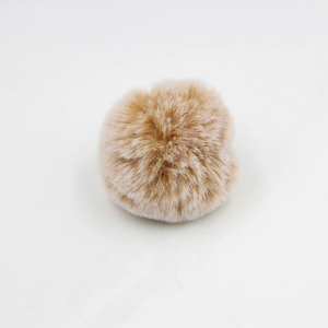 Close-up of soft beige 8cm faux rabbit fur pom pom for bags and keychain accessories