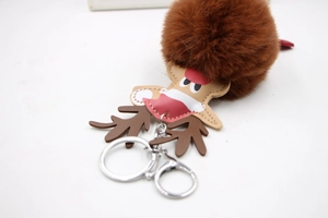 Detailed close-up of brown plush reindeer pom-pom keychain with silver lobster clasp