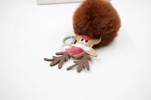 Detailed close-up of brown faux fur reindeer keychain with festive leather elk design