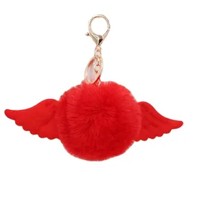 Cute red faux fur pompom keychain with plush angel wings and golden metal lobster clasp