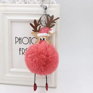 Plush Christmas reindeer pompom keychain with pink faux fur and red Santa hat