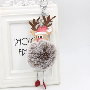 Detail view of a reindeer plush ball keychain with red Santa hat and metal lobster clasp