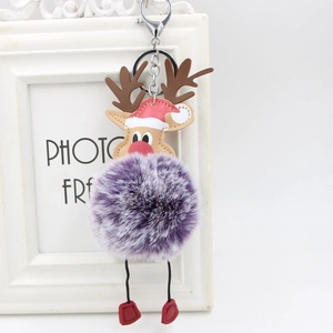 Detail of reindeer plush keychain with purple gradient faux fur ball and metal clasp