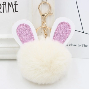 Detail of plush bunny ear keychain featuring white faux fur and pink glitter inner ears