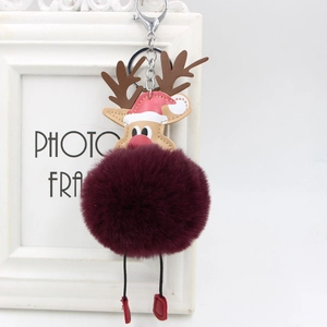 Detail of burgundy faux fur reindeer keychain with leather antlers and silver lobster clasp