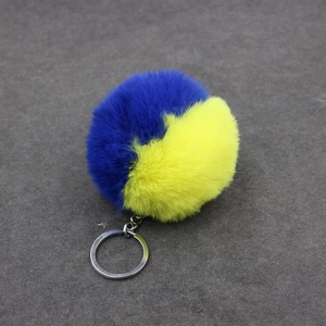 Détail du porte-clés bicolore en fausse fourrure bleue et jaune avec anneau