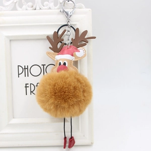 Close-up of reindeer plush ball keychain with a red Santa hat and metal lobster clasp