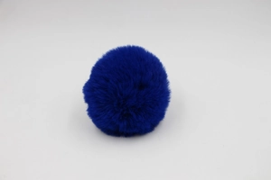 Close-up of royal blue faux fur pompom with soft texture and uniform round shape