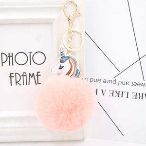 Colorful plush unicorn pompom keychain with pink faux fur ball and gold lobster clasp