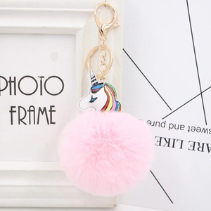 Pink faux fur pompom keychain with colorful unicorn pendant and golden metal ring