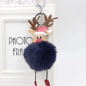 Detail of plush Christmas reindeer bag charm with dark blue fur ball and silver carabiner