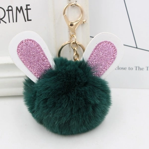Detail of dark green plush rabbit ear keychain with pink sequins and gold metal clasp