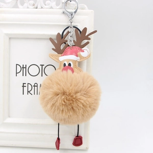 Close-up of reindeer plush keychain with beige faux fur ball and silver metal lobster clasp