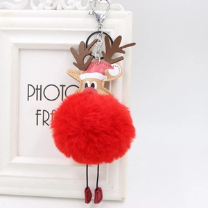 Detail of creative Christmas reindeer plush keychain with red faux fur pompom and silver clasp