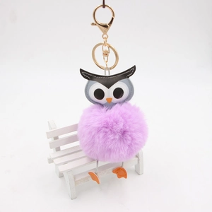 Vue détaillée du porte-clés pompon chouette en fausse fourrure violette et doré