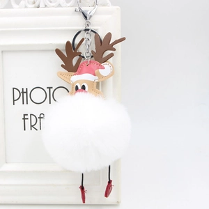 Detail of reindeer Christmas plush pompom keychain with white fur ball and silver clasp