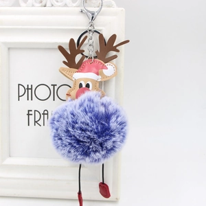 Detail of Christmas reindeer keychain with colorful fur pompom and leather deer charm