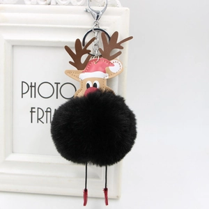 Detail of reindeer faux fur pompom keychain with red Christmas hat and silver metal clasp