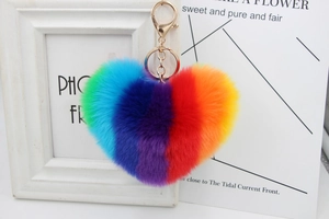 Close-up of heart-shaped rainbow plush keychain with high-quality faux fur and golden hook