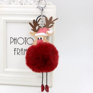 Close-up of reindeer plush charm with fluffy red faux fur pompom and festive hat