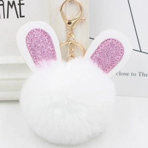 Detail of plush rabbit keychain with sparkling pink glitter ears and golden metal clasp