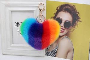 Close-up of rainbow heart plush keychain with golden metal ring and lobster clasp