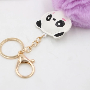 Cute panda pompom keychain featuring a purple faux fur ball and golden metal clasp