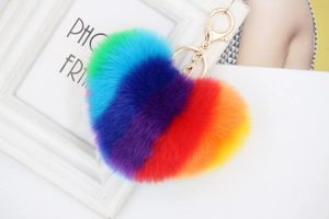 Close-up of rainbow faux fur heart keychain with golden metal ring and lobster clasp