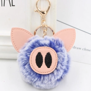 Close-up of cute purple plush pig keychain with soft faux fur and golden alloy lobster clasp