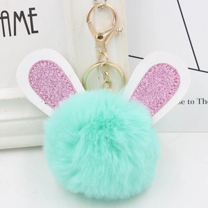 Detail of mint green plush bunny keychain with pink glitter ears and gold alloy clasp