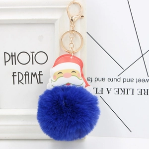 Close-up of Santa Claus leather charm with soft royal blue pompom and golden keyring