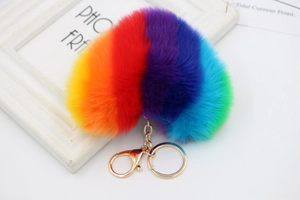 Detailed close-up of rainbow faux fur heart keychain with golden metal lobster clasp