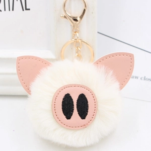 Cute white plush pig keychain with soft pom-pom fur and golden metal lobster clasp