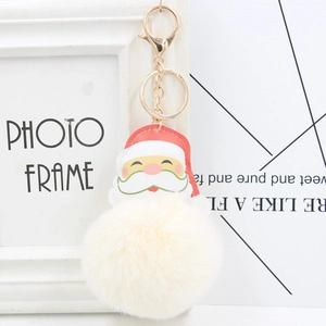 Close-up of Santa Claus PU leather pendant with fluffy white pom pom and golden lobster clasp