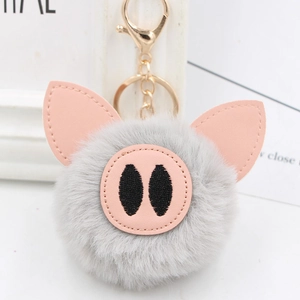 Close-up of cute grey plush pig keychain with pink PU ears and gold metal clip