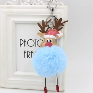 Detail of light blue reindeer pompom keychain with brown antlers and a festive Christmas hat