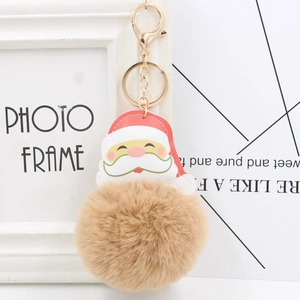 Detail of Santa Claus keychain with brown faux fur pom pom and golden metal clip