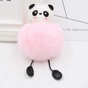 Detail of cute panda plush keychain with pink pompom and soft faux fur for bags