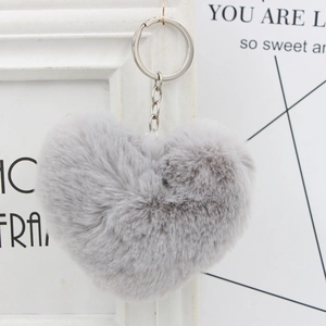 Close-up of soft grey plush heart keychain with silver metal clip for handbags